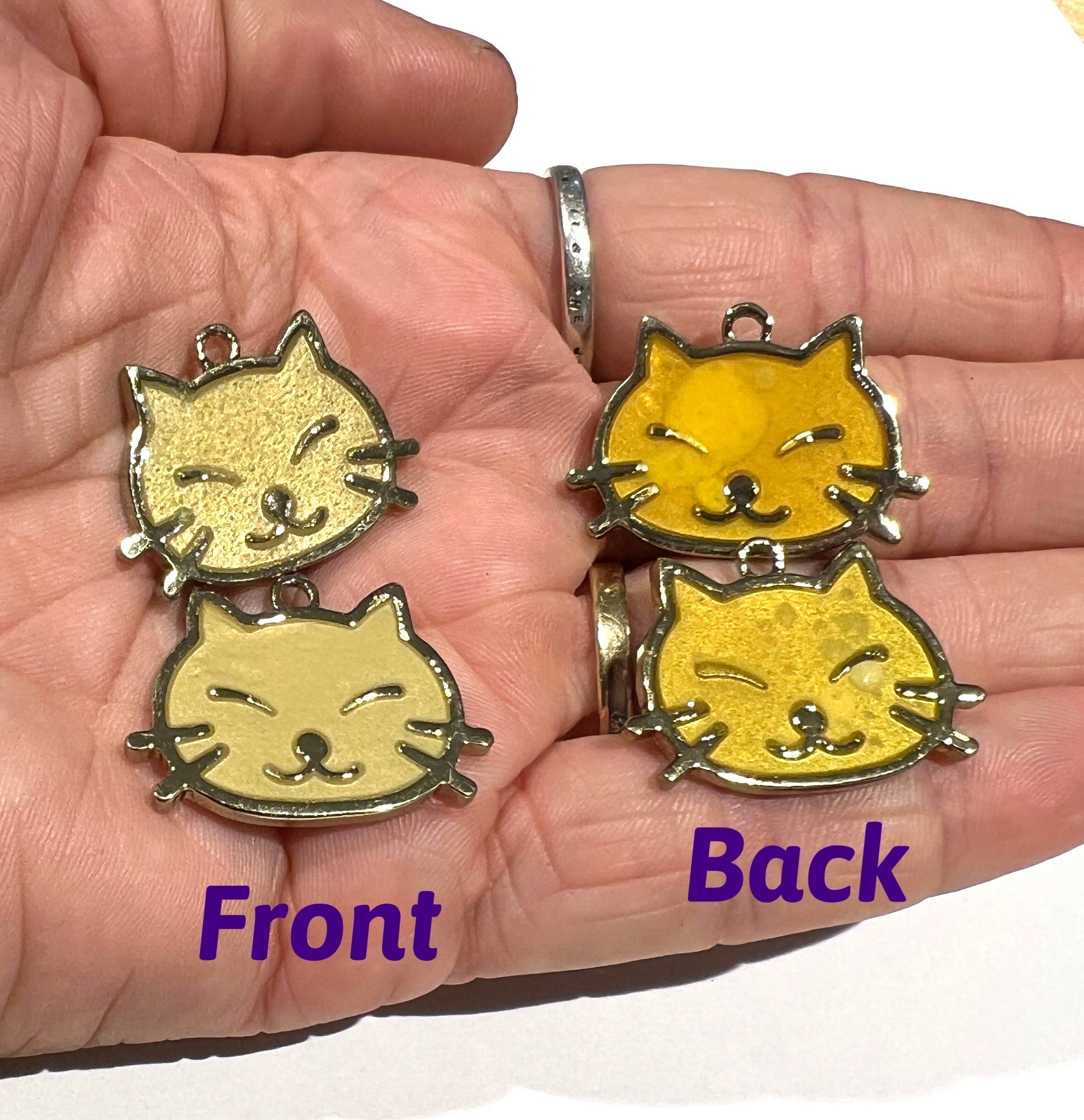 A glowing cat faces breakaway collar made of reinforced cotton, featuring a bell and charm, perfect for nighttime visibility.